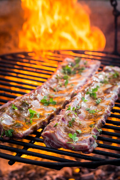 istock Spicy ribs with thyme and spices on grill 695701098
