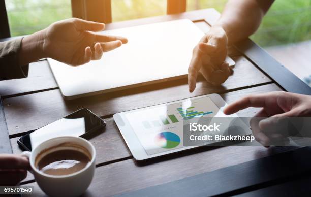 Closeup Business Group Meeting Show Analysis Graph On Tablet Device Stock Photo - Download Image Now