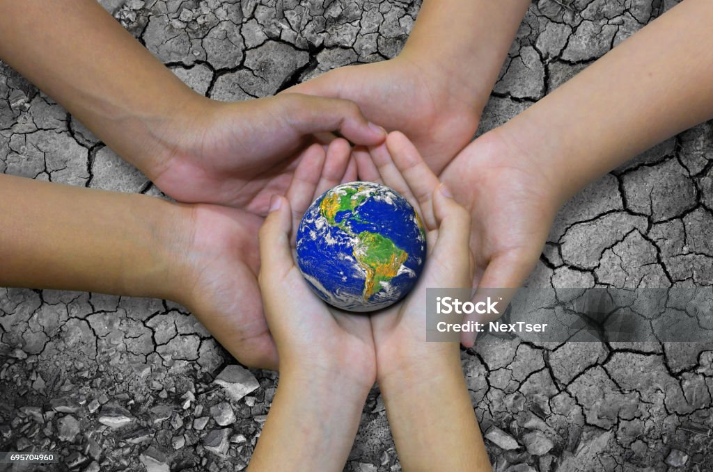 Earth planet in asian Children hand isolated on Ground arid barren Earth planet in asian Children hand isolated on Ground arid barren- Elements of this image furnished by NASA Barren Stock Photo