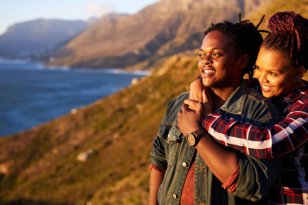istock Mixed race couple looking out towards the view outdoors together 695705080