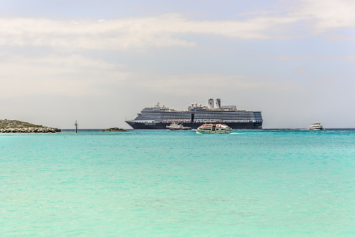 Little San Salvador Island, Bahamas - April 1, 2017: Holland America cruise ship arrived at company's private island - Half Moon Cay. Half Moon Cay is also known as Little San Salvador Island, is one of the islands that make up the arechipelago of the Bahamas. The island does not have deep water docking, requireing the use of tenders for cruise ship passengers to disembark and embark.