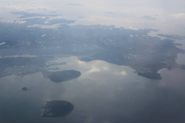 istock Modern aircraft flies over the island 695708572