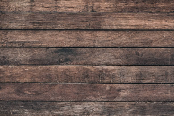 istock Vintage surface wood table and rustic grain texture background. Close up of dark rustic wall made of old wood table planks texture. Rustic brown wood table texture background template for your design. 695708800