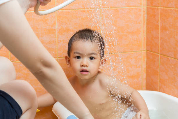 istock Child bathing with mother in bathroom 695721650