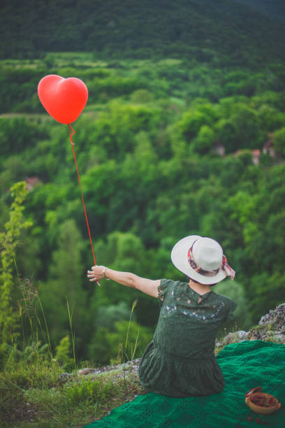 istock Girl with baloon on the edge 695722064
