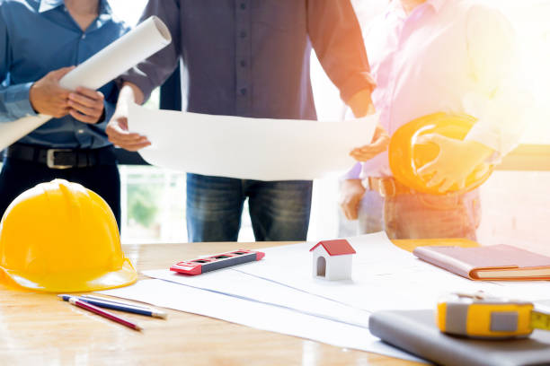 istock Team of engineers working together in a architect office. 695722078