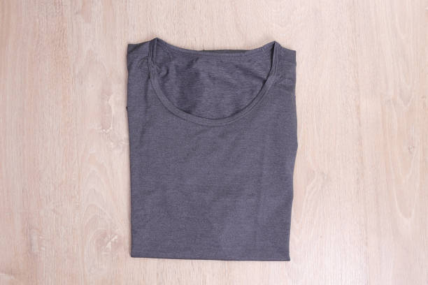 istock Top view fold gray t-shirt on wooden background 695725232