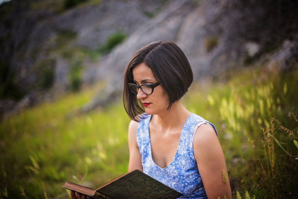 istock Beautiful girl reading a book 695733804