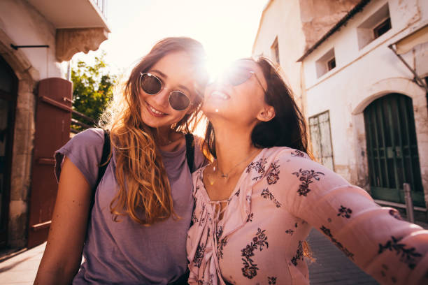 Women on Mediterranean vacations taking a selfie in a city