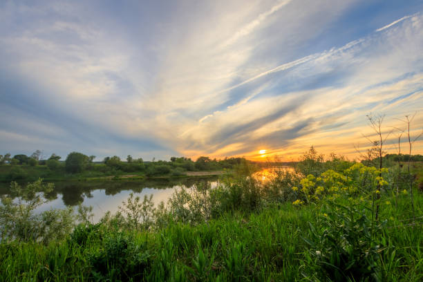 istock Sunset above the river at summer with cloudy sky background. 695748968