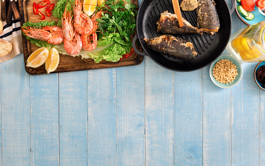 Shrimp grilled, fish grilled on a blue wooden table with copy space, top view
