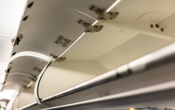 istock luggage rack on airplane 695759640