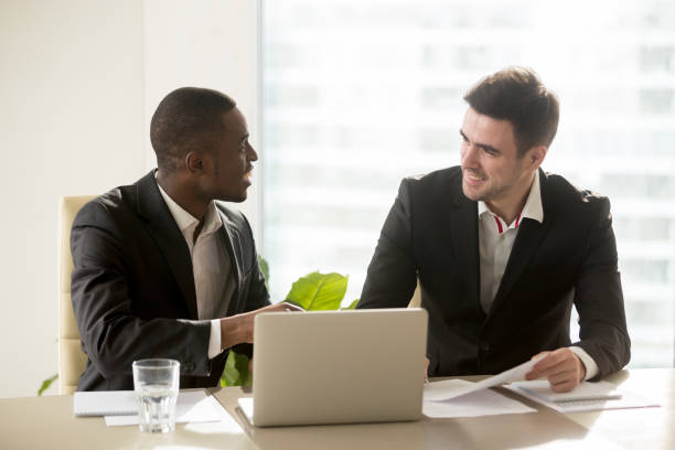istock Two accomplished multiracial businessmen discussing business projects at office desk 695760010