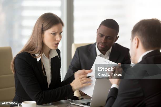 Angry Dissatisfied Businesswoman Arguing With Contractor Pointing At Contract Stock Photo - Download Image Now