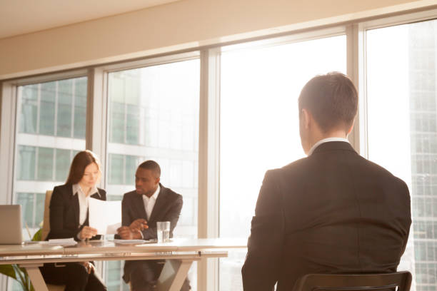 istock Nervous applicant waiting on chair for interview result, rear view 695760200