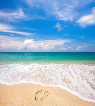 footprints on beach and tropical sea