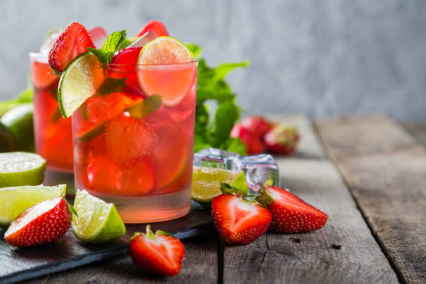 istock Strawberry mojito and ingredients on rustic background 695763482