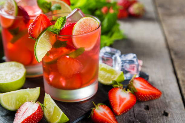 istock Strawberry mojito and ingredients on rustic background 695763528