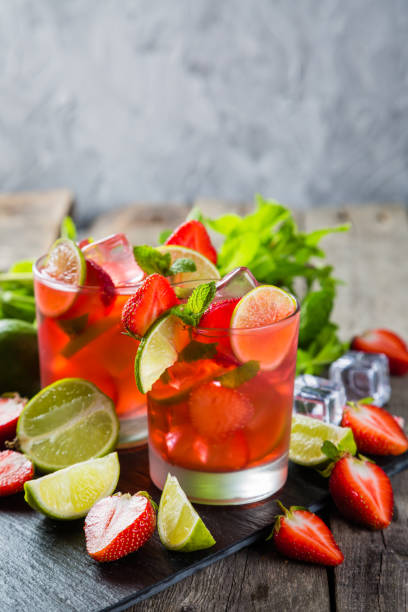 istock Strawberry mojito and ingredients on rustic background 695763758