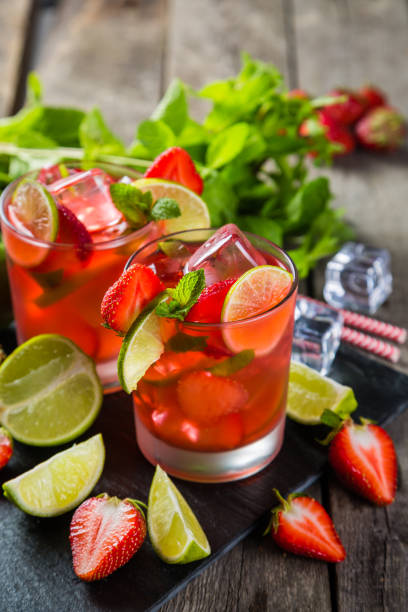 istock Strawberry mojito and ingredients on rustic background 695763878