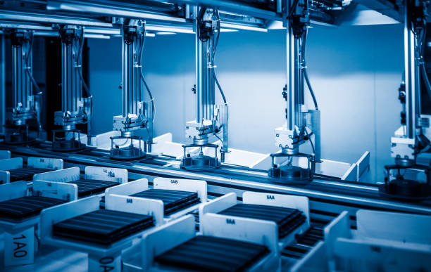 workers and machinery in a solar panel manufacturing industry factory workers and machinery in a solar panel manufacturing industry factory. solar panel manufacturing stock pictures, royalty-free photos & images