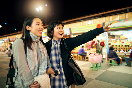 Shot of two young women exploring a Taiwanese night market