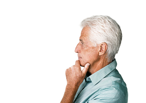 Studio profile of a senior man looking thoughtful against a white background