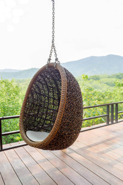 istock rattan lounge hanging chair writh white  pillow 695776072