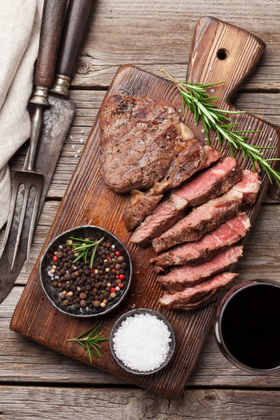 istock Grilled beef steak with spices on cutting board 695777432