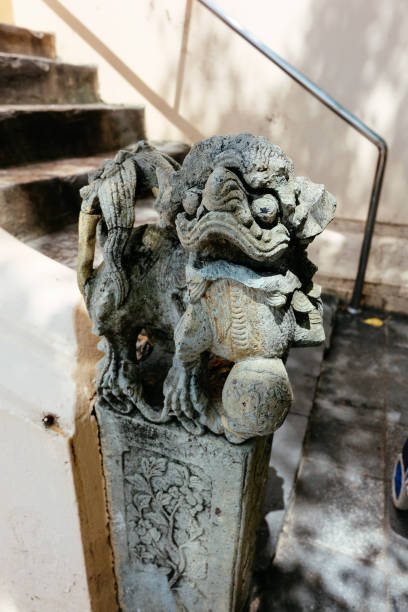 istock Lion statue in temple with sun light 695779618