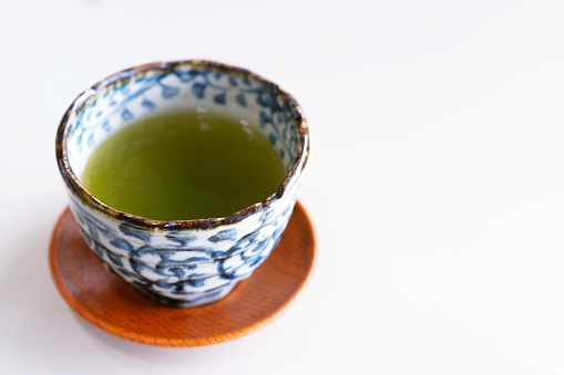 Japanese green tea in a simple white and blue cup.