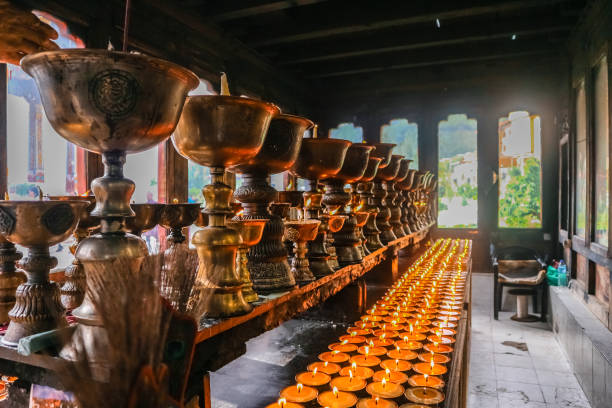 Lighting of praying candles in Zangdhopelri Monastery in Thimphu, Bhutan stock photo