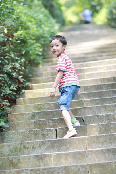 istock Little boy walks in the park 695792462