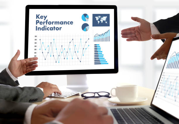 istock KPI acronym (Key Performance Indicator) Business team hands at work with financial reports and a laptop 695793352