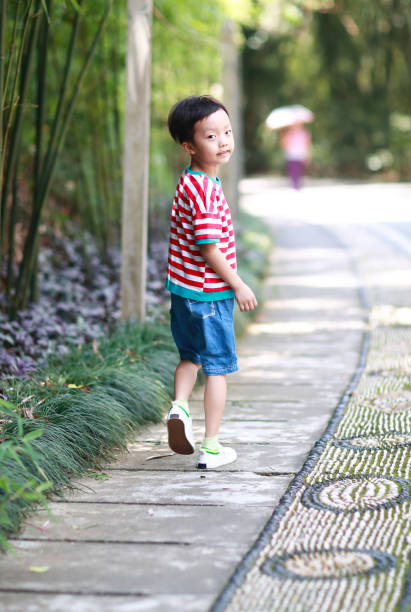 istock Little boy walks in the park 695795864