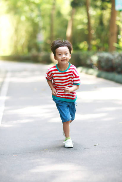istock Little boy running in the park 695796280