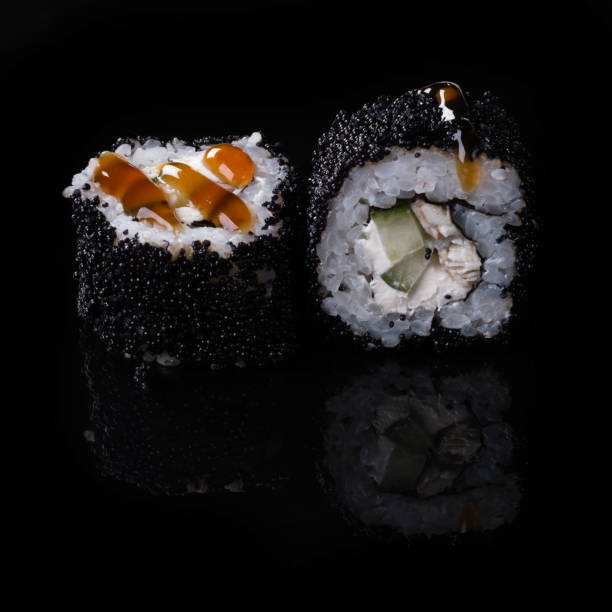 istock sushi on black background 695796634