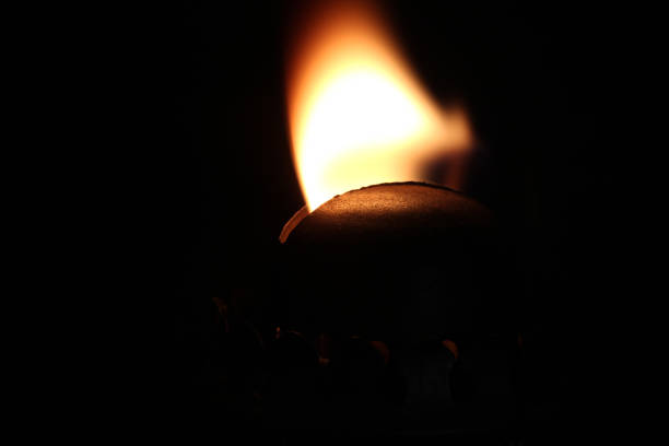 Close up of burning candle, on black background