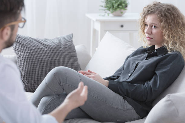 istock Woman sitting on a sofa 695799266