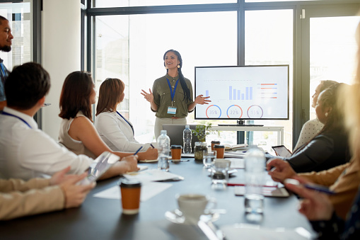 Cropped shot of an attractive young businesswoman giving a presentation in the boardroom