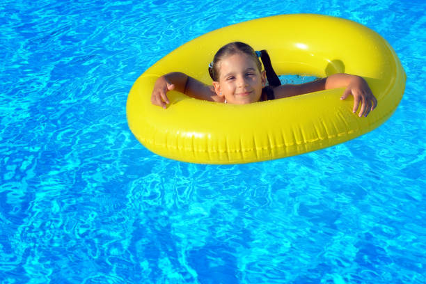 istock Adorable toddler relaxing in swimming pool 695820752