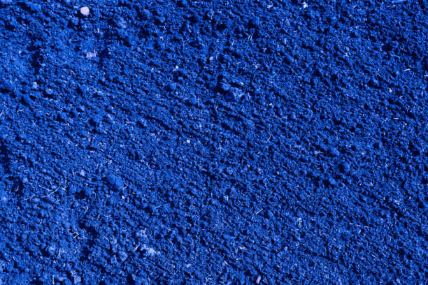 istock Dark blue color plowed dirt. Background and texture 695821646