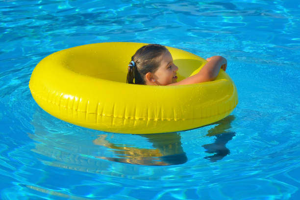 istock Adorable toddler relaxing in swimming pool 695822820
