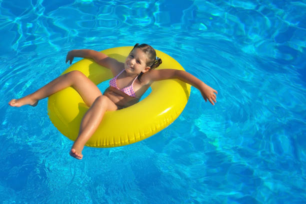 istock Adorable toddler relaxing in swimming pool 695827630