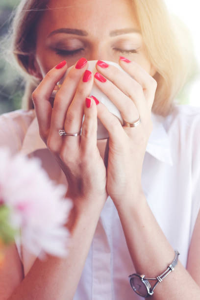 istock Pretty young woman drinking a cup of coffee 695831190