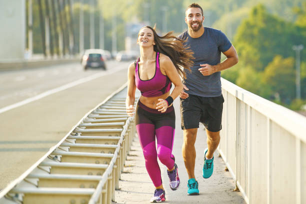 istock Couple jogging on the bridge 695835170