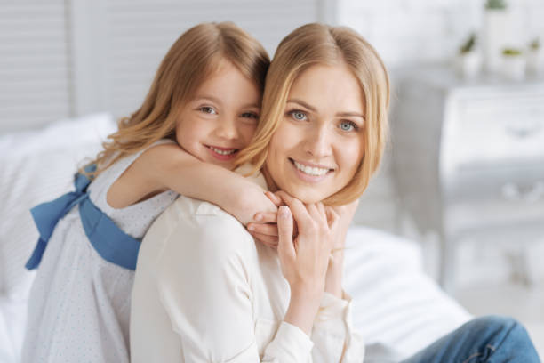 istock Cute little daughter hugging her mother 695842268