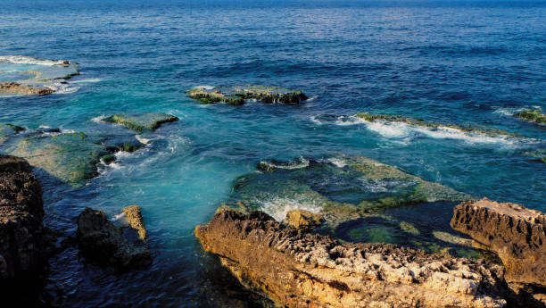 istock coast with rocks at the sea, clear blue and emerald colored water 695847024