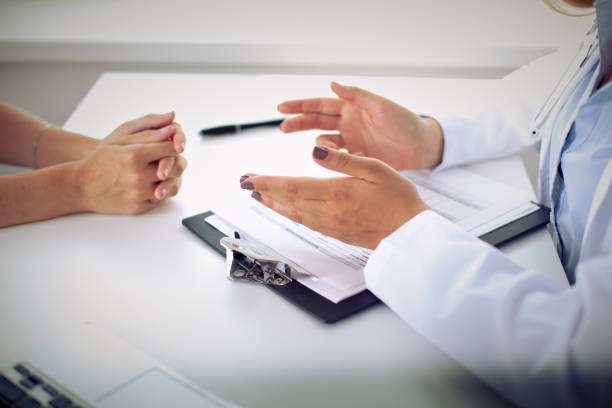 istock Doctor and patient are discussing something, just hands at the table 695847904