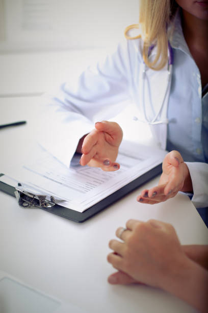 istock Doctor and patient are discussing something, just hands at the table 695848022